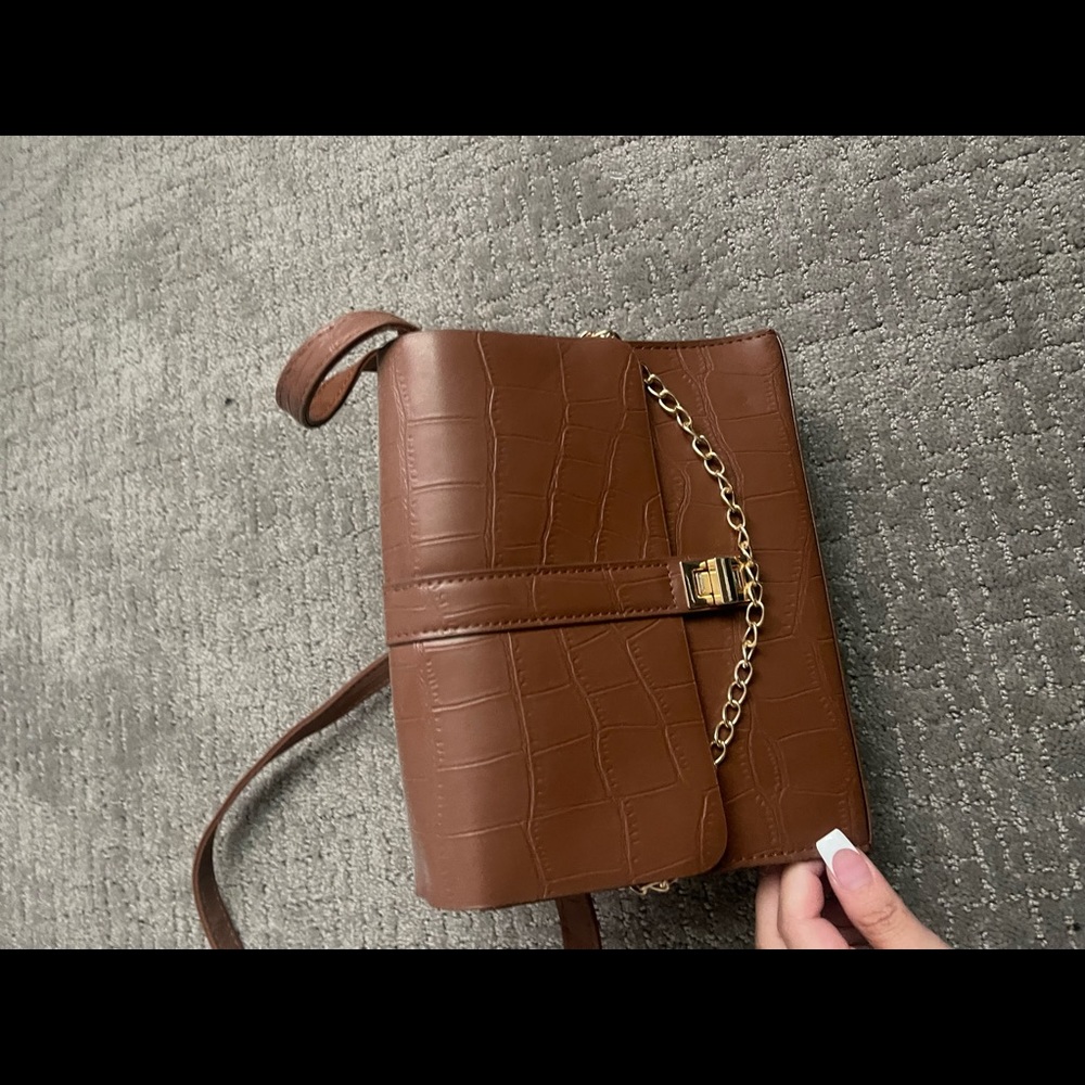Brown crossbody purse. Textured, and gold chain in front. Never used.